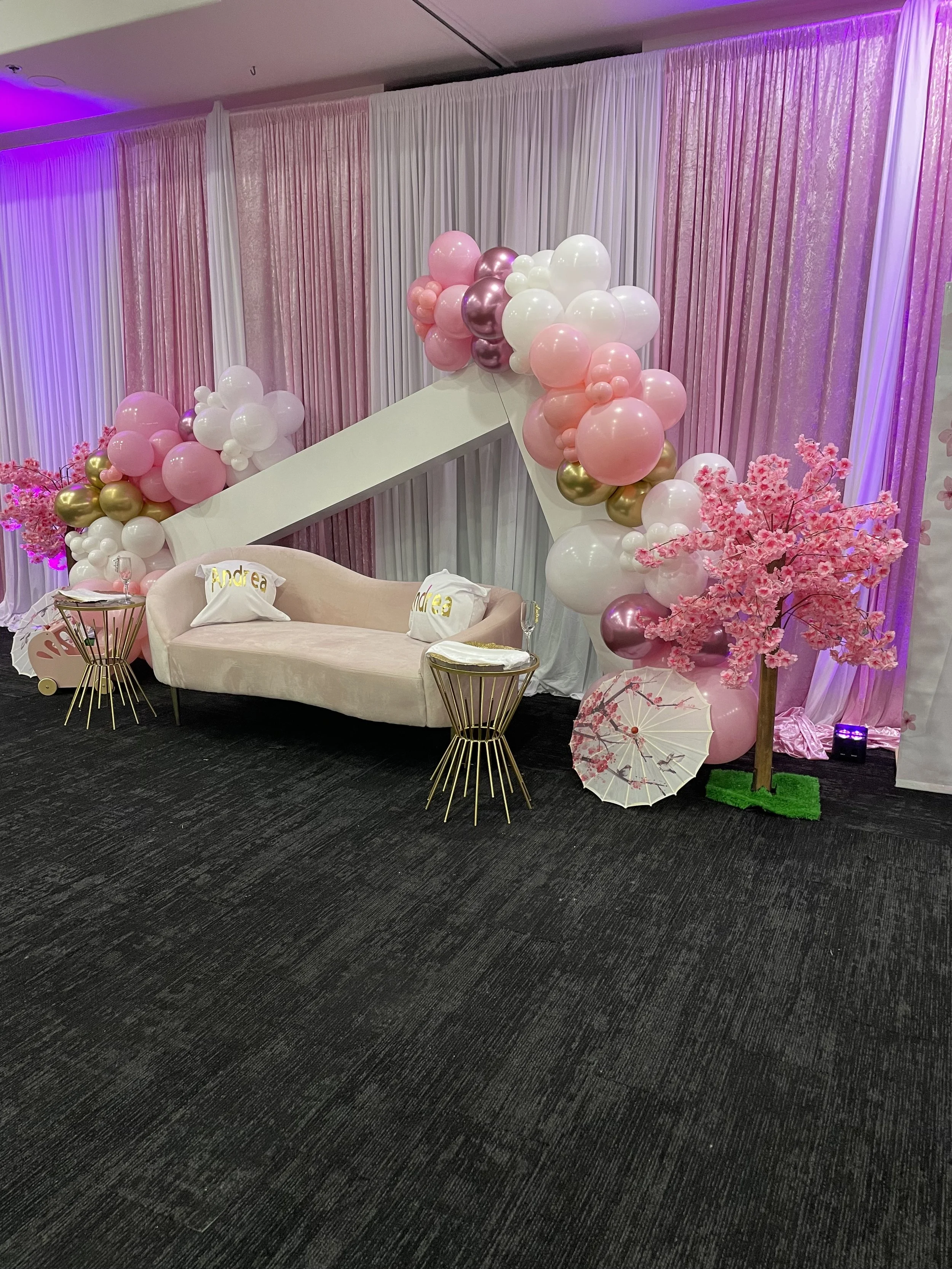 Pink baby shower lounge with balloon garland