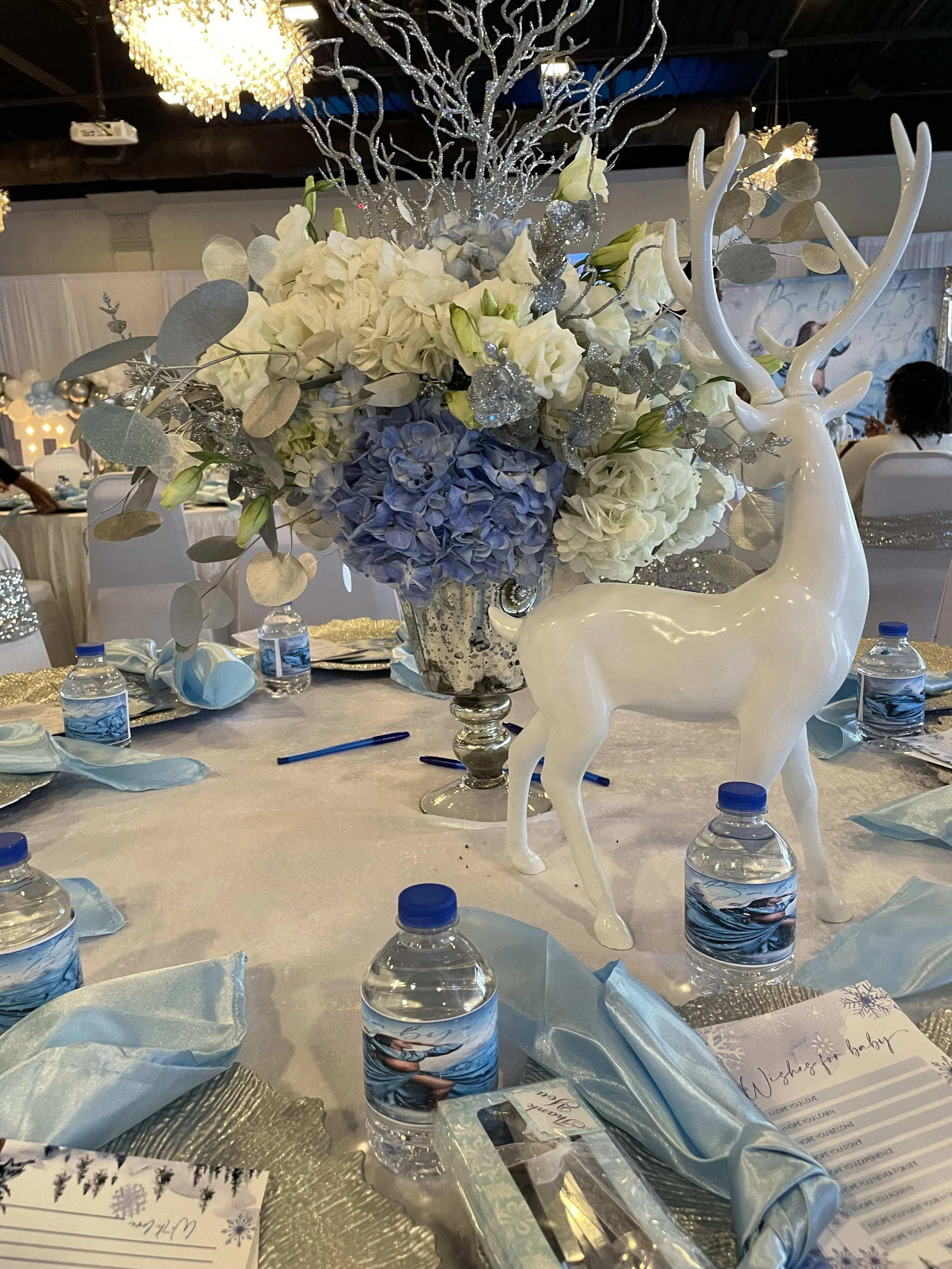 Baby shower centerpiece with white deer and blue florals
