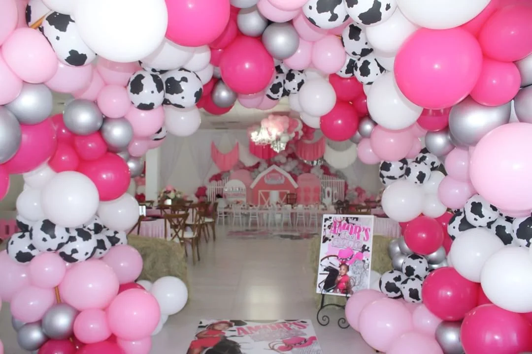 Pink and cow-print balloon garland