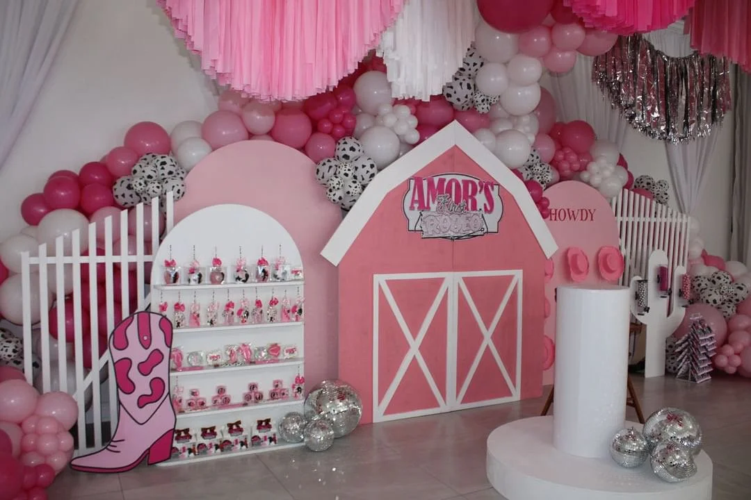 Pink barnyard kids birthday party with balloon garland, backdrop and white chiavari chairs by Sharp Designs