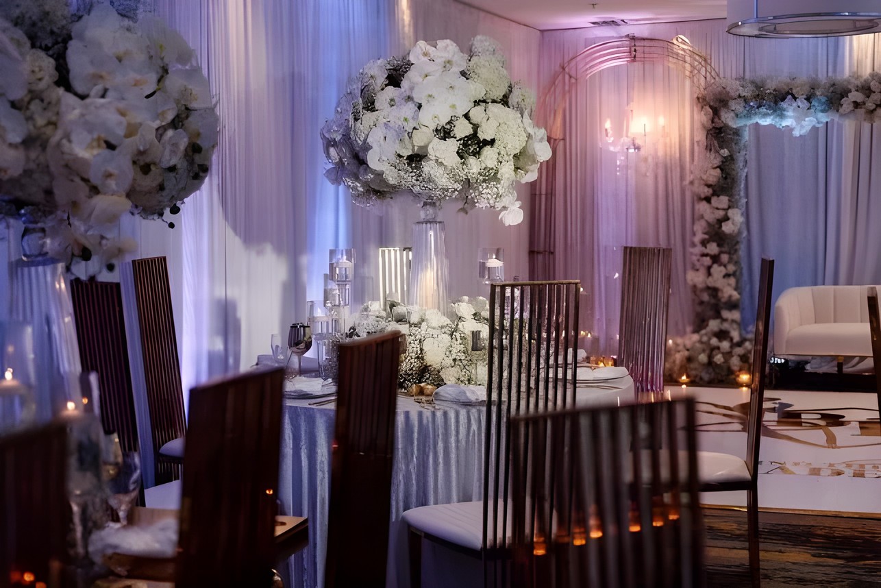 Wedding ballroom with uplighting and white florals