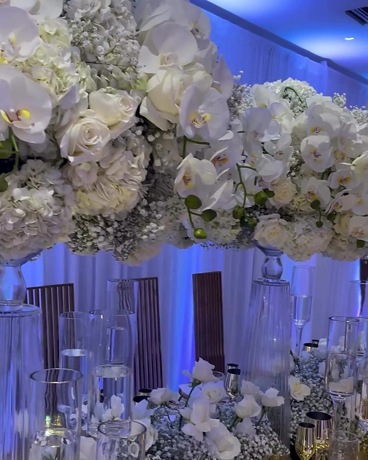 Tall white orchid and rose wedding centerpiece